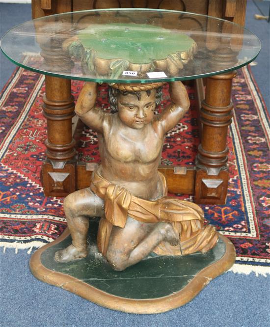 A carved Venetian style amorini table base, with plate glass top, H.70cm